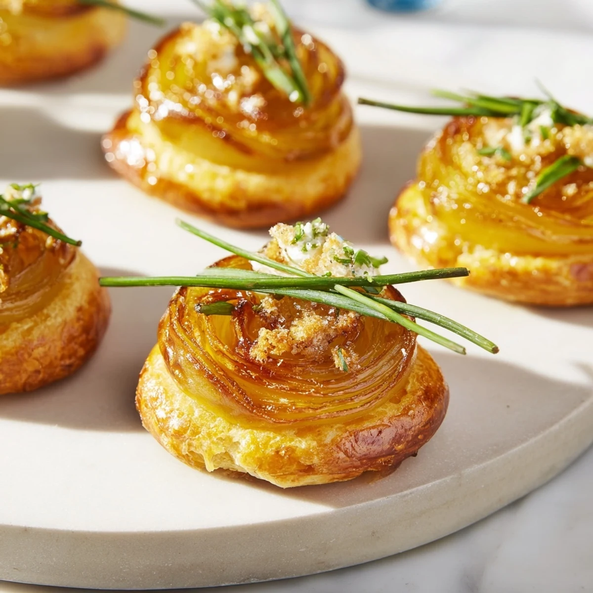 Golden caramelized onions topping this decadent Caramelized Onion and Goat Cheese Tart, ready to serve and enjoy.