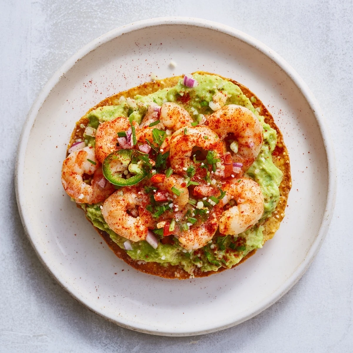 Enjoy freshly made Quick Shrimp and Avocado Tostadas; featuring spicy shrimp and creamy avocado on crispy tostada shells.