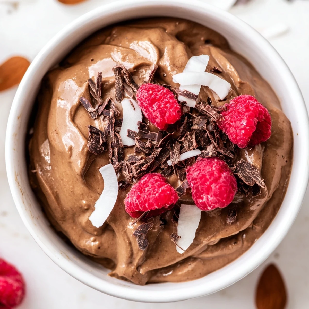 Creamy chocolate avocado mousse, rich in flavor and garnished with toasted almonds and flakes.