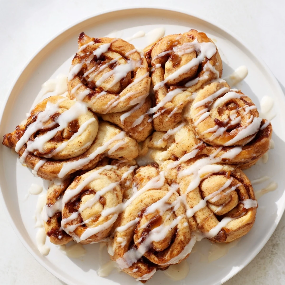 Golden-brown Cinnamon Roll Pull-Apart Snowflake with glistening icing, perfect for a cozy breakfast treat.