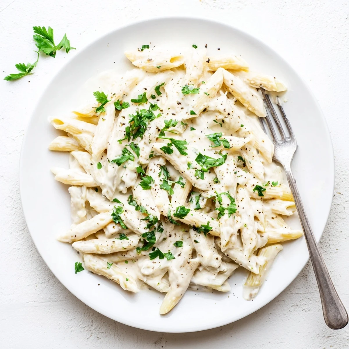 A skillet of Creamy Milk Pasta One-Pot, with golden Parmesan melted into the velvety sauce, garnished with fresh parsley.