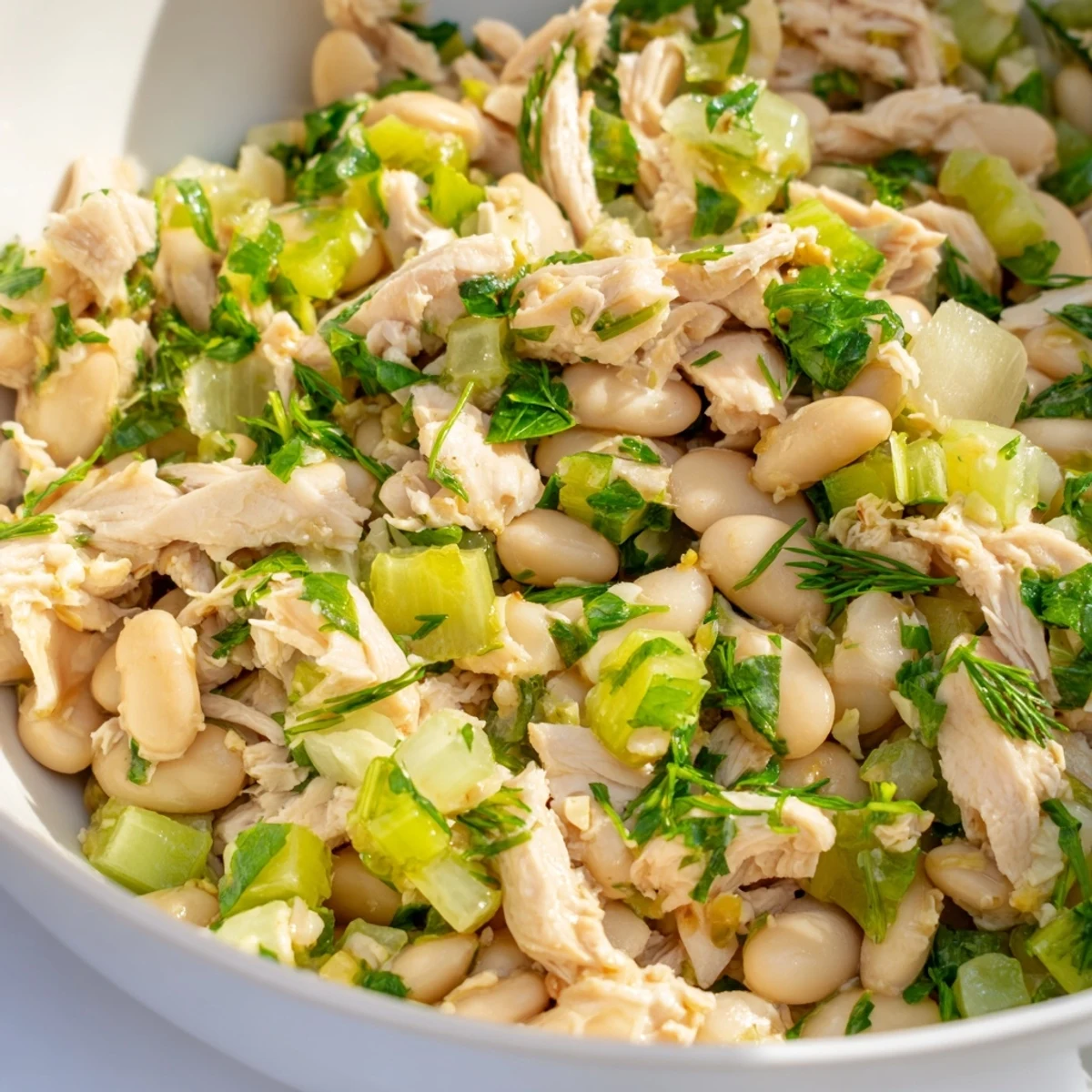 Colorful bowl of Lemony White Bean Chicken Salad, perfect for a light, protein-packed lunch or summer main dish.