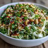A refreshing bowl of Asian Cabbage Salad featuring purple cabbage, carrots, and a spicy lime kick.