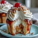 Fluffy tres leches cupcakes soaked in sweet three-milk blend and topped with whipped cream and berries.