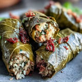 Kurdish Dolma: tender, herb-filled grape leaves resting in a serving dish.