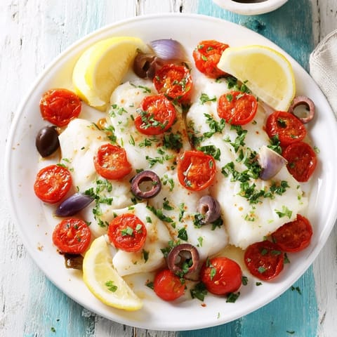 Golden and flaky, One-Tray Baked Cod showcases tender fish amidst juicy tomatoes and briny olives.