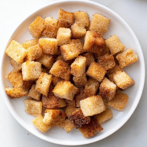 Bite-sized French Toast Cereal, beautifully golden brown, ready to be enjoyed with milk or syrup.