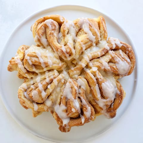 Warm, soft Cinnamon Roll Pull-Apart Snowflake oozing cinnamon filling, ready to be pulled apart and shared.