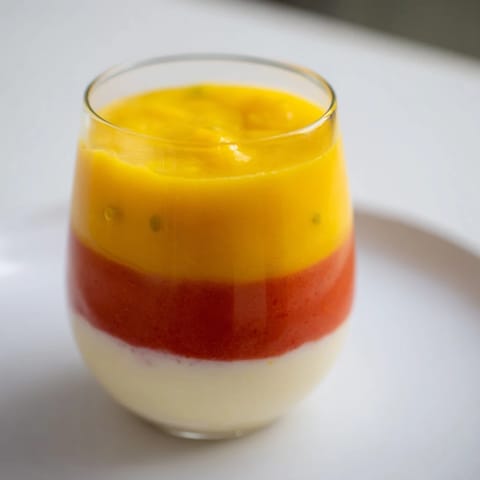 Layers of creamy yogurt and fruit compose this refreshing Tropical Sunset Smoothie, perfect on a hot day.