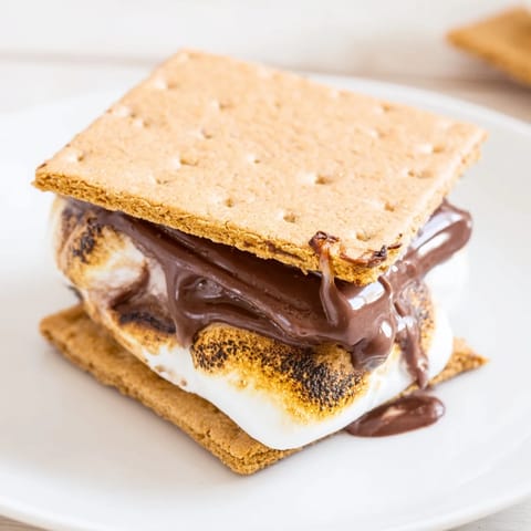 Warm, gooey S'mores from the air fryer stacked high with chocolate and marshmallow.