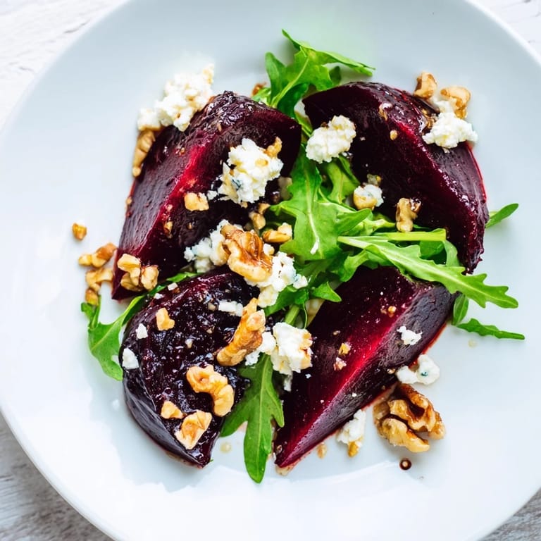 Roasted beet goat cheese salad garnished with chopped chives, ready to serve with a light balsamic vinaigrette on a rustic table.