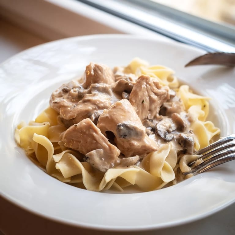 Hearty Chicken and Mushroom Stroganoff on a plate, featuring golden chicken, sautéed mushrooms, and a rich creamy sauce.