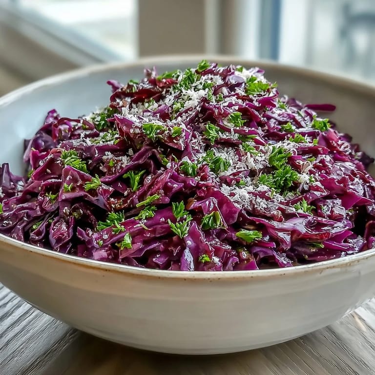 Shredded Red Cabbage Coleslaw With Apple and Parmesan tossed with crisp apple slices and spring onions, ready to serve as a refreshing vegetarian side dish.