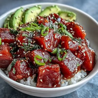 Vibrant Spring Tuna Poke Bowl bursting with fresh seafood and crisp vegetables.